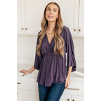 Switch up your wardrobe with this Love On The Line Purple Peplum Blouse! Made from a slinky knit beautiful purple