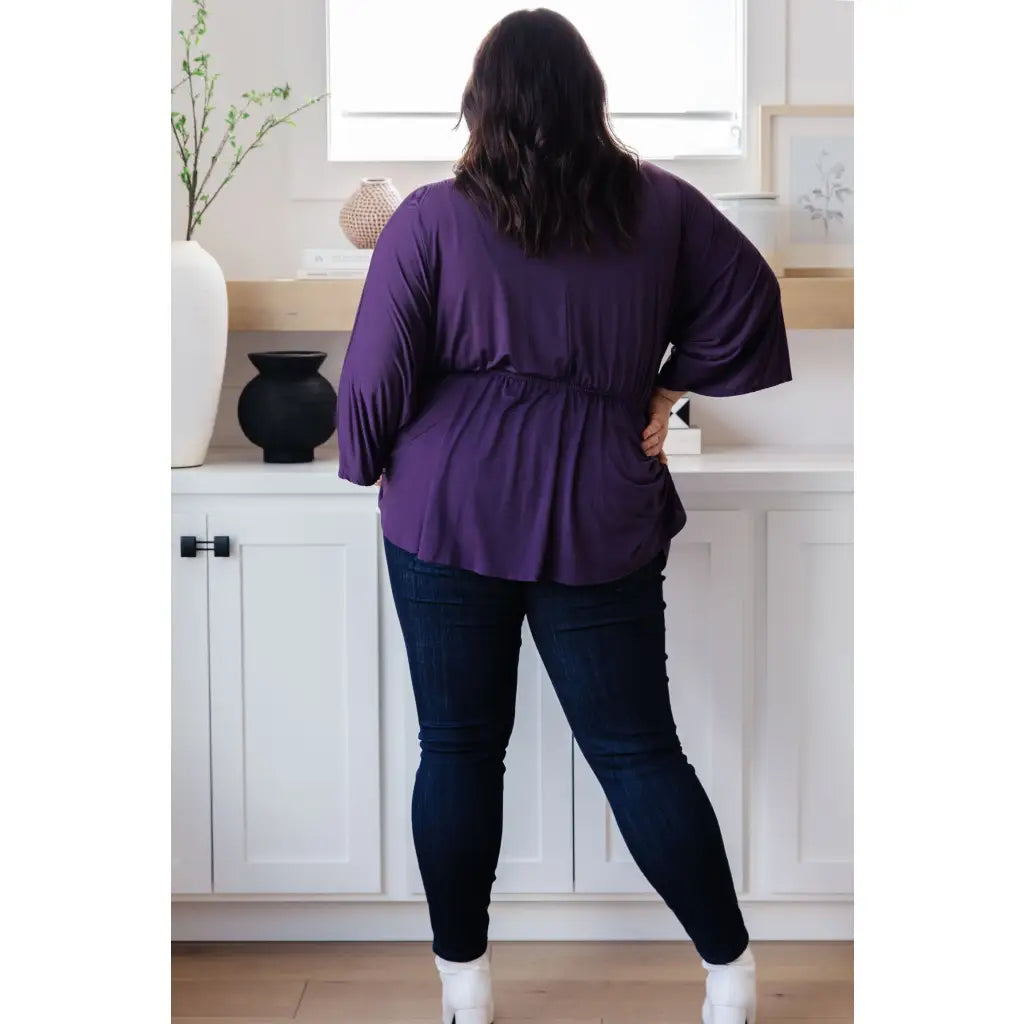 Switch up your wardrobe with this Love On The Line Purple Peplum Blouse! Made from a slinky knit beautiful purple