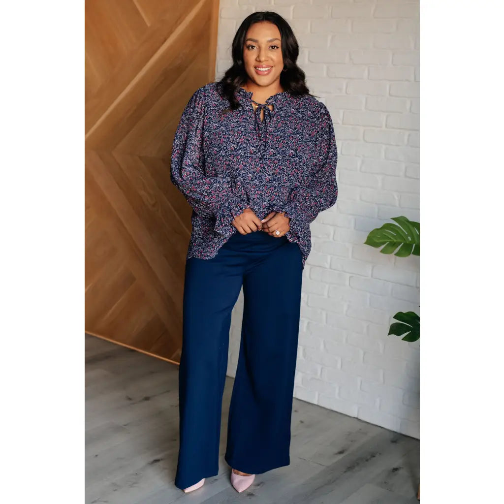 Add a touch of dreamy romance with our Lucid Dream Ruffle Neckline Blouse in Navy. Made crinkle woven fabric ditsy