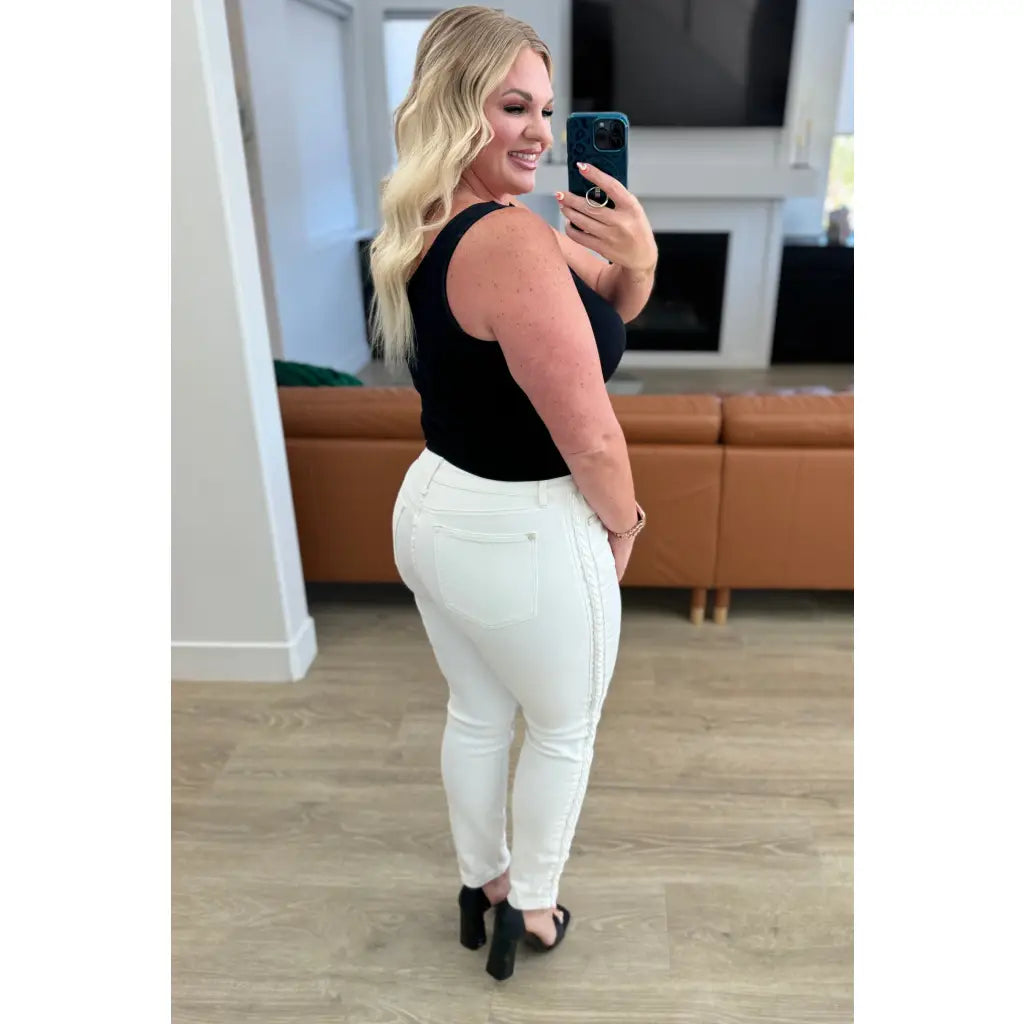 Shop Maddie Mid Rise Braided Side Seam Jeans from Judy Blue. Crisp white denim 4-way stretch braided detail relaxed