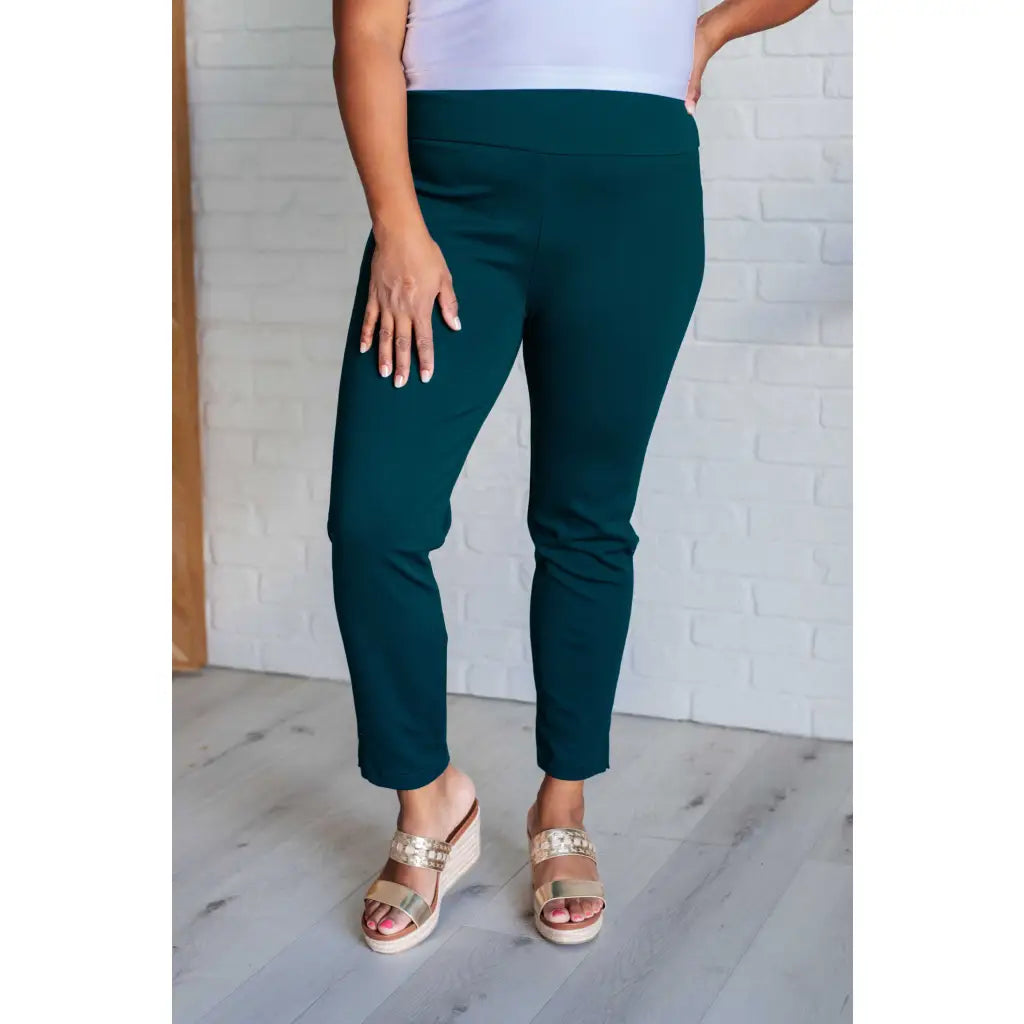 Our Magic Skinny Pants in Hunter Green are high rise ankle cropped pants featuring a slim fit and ponte knit