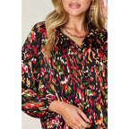 Chic abstract print tunic blouse with flowy fit and ruffled neckline. Sizes SM–3XL. Perfect plus size office top