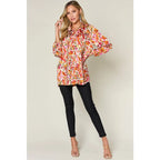 Chic abstract print tunic blouse with flowy fit and ruffled neckline. Sizes SM–3XL. Perfect plus size office top