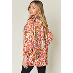 Chic abstract print tunic blouse with flowy fit and ruffled neckline. Sizes SM–3XL. Perfect plus size office top