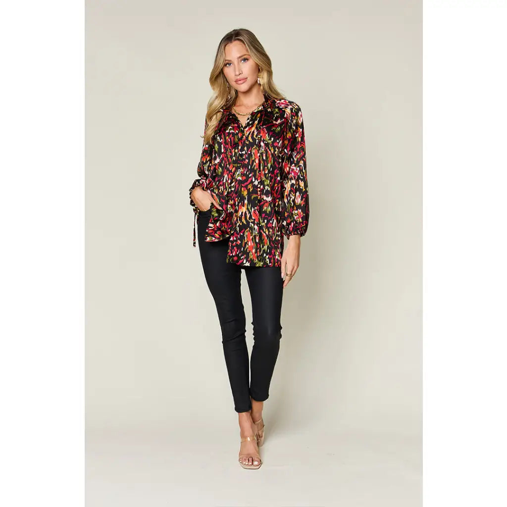 Chic abstract print tunic blouse with flowy fit and ruffled neckline. Sizes SM–3XL. Perfect plus size office top
