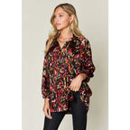Chic abstract print tunic blouse with flowy fit and ruffled neckline. Sizes SM–3XL. Perfect plus size office top