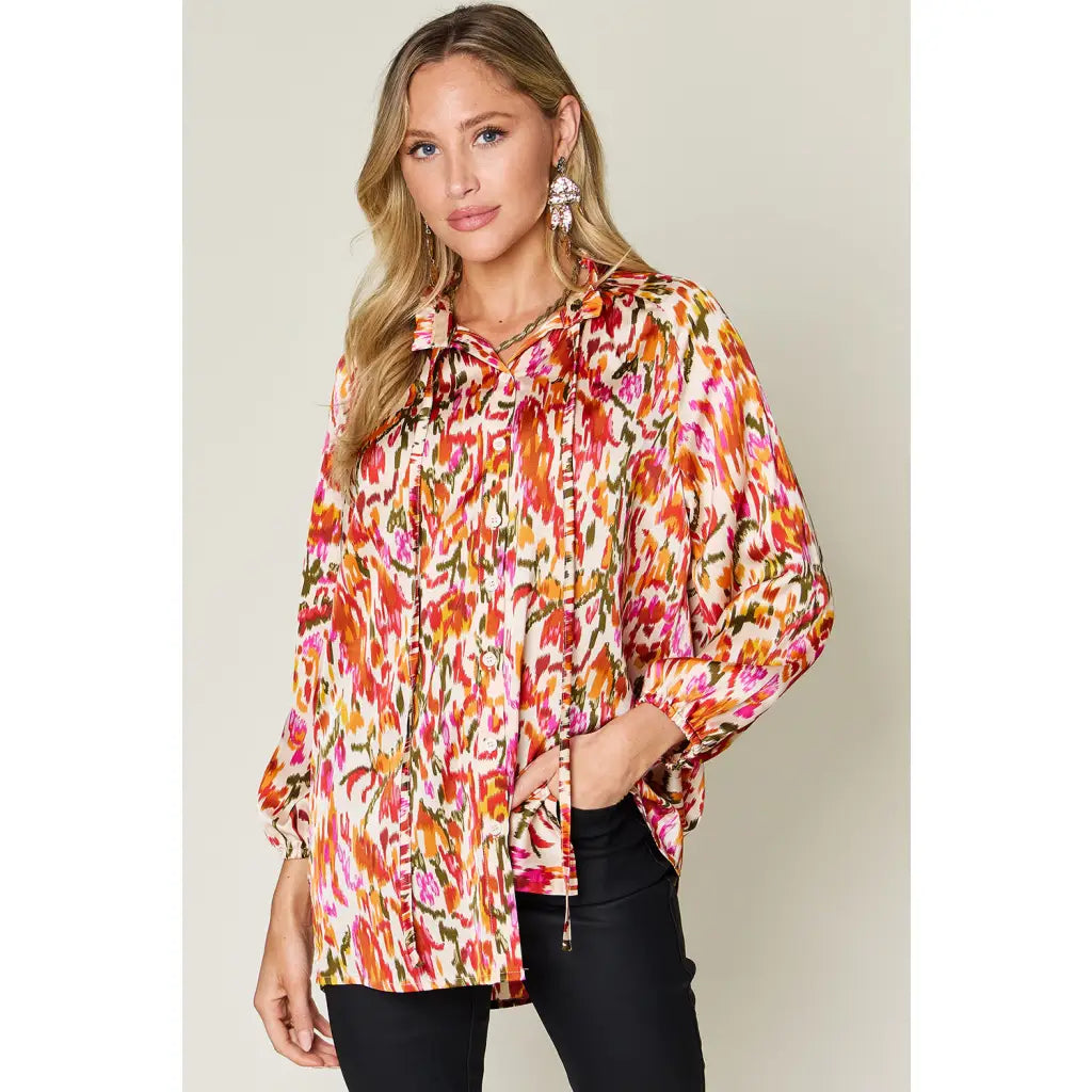 Chic abstract print tunic blouse with flowy fit and ruffled neckline. Sizes SM–3XL. Perfect plus size office top