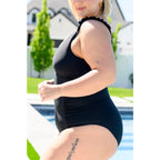 Chic black one-piece swimsuit with ruffle straps v-neckline ruching and removable cups. Plus size swimwear