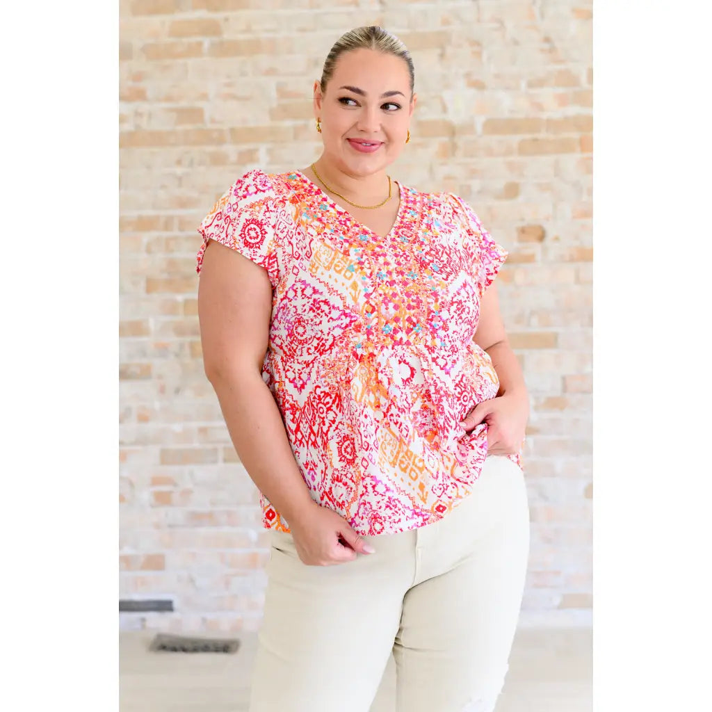 Stay on trend with our A Matter of Time Flutter Sleeve Top in Multi Pink! This woven top features a flattering v