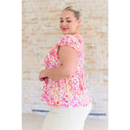 Stay on trend with our A Matter of Time Flutter Sleeve Top in Multi Pink! This woven top features a flattering