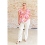 Stay on trend with our A Matter of Time Flutter Sleeve Top in Multi Pink! This woven top features a flattering