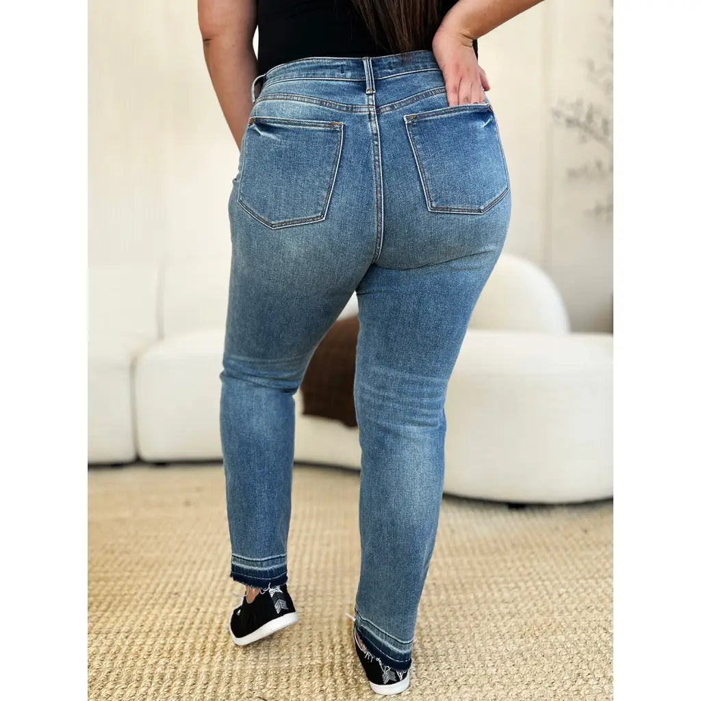 Discover the chic Judy Blue Mid Rise Rigid Magic Release Hem Jeans available in regular curvy and plus sizes. Shop