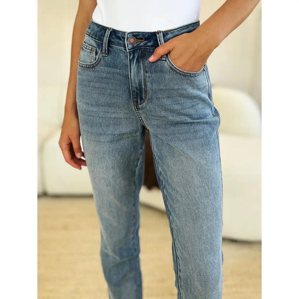 Discover the chic Judy Blue Mid Rise Rigid Magic Release Hem Jeans available in regular curvy and plus sizes. Shop