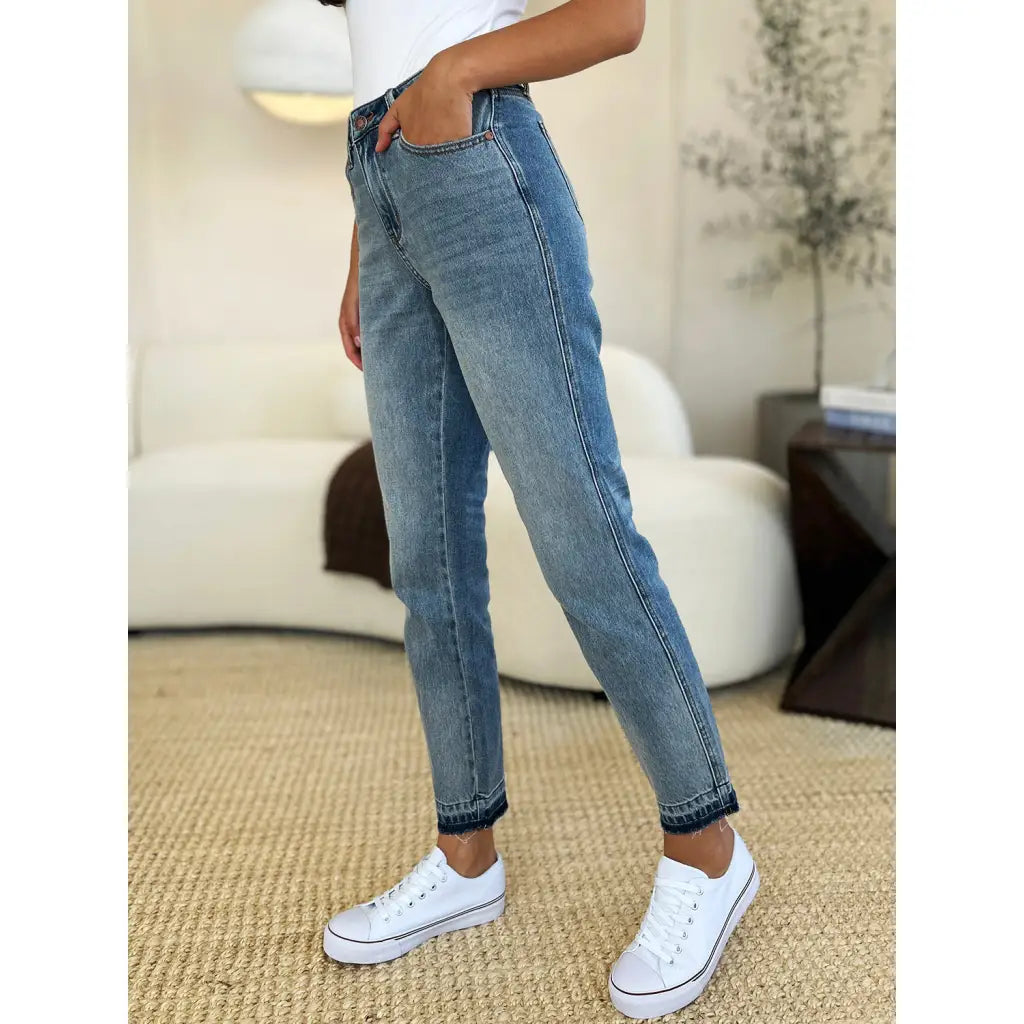 Discover the chic Judy Blue Mid Rise Rigid Magic Release Hem Jeans available in regular curvy and plus sizes. Shop