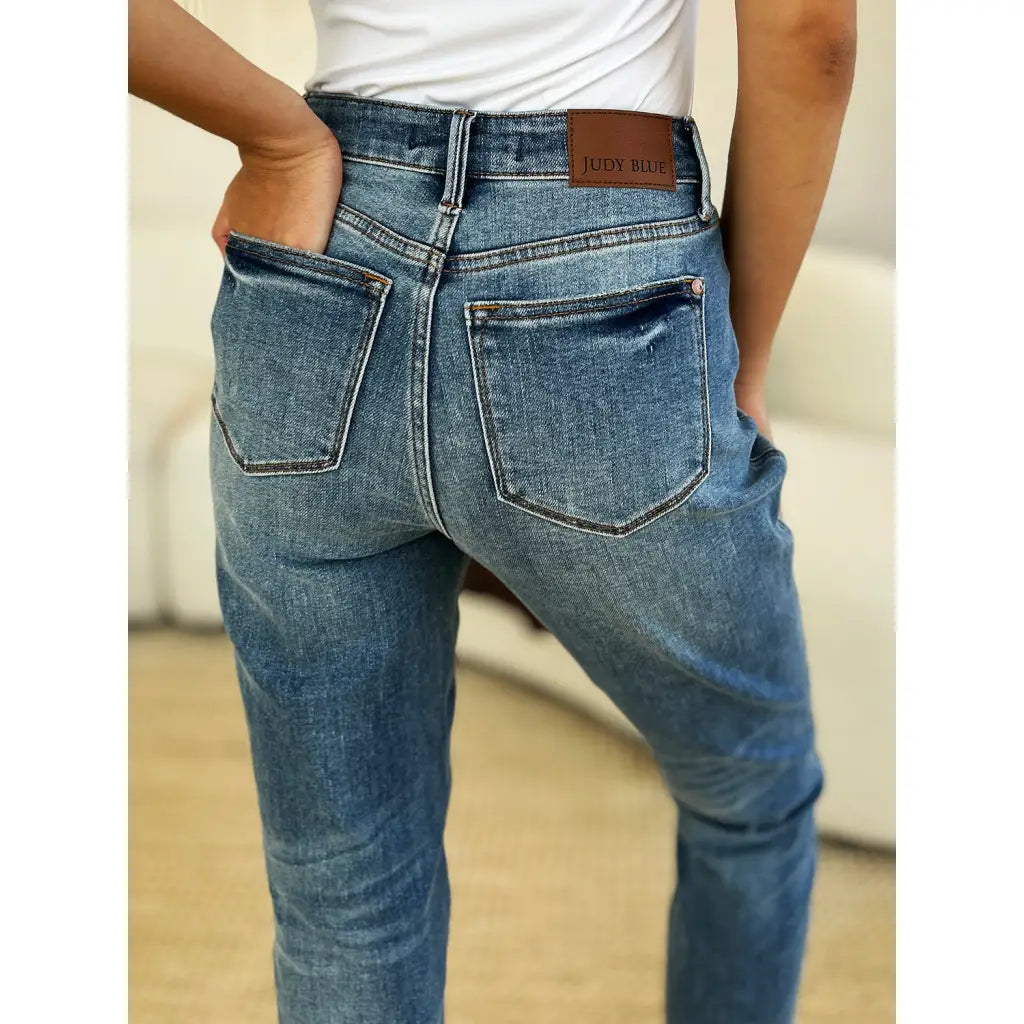 Discover the chic Judy Blue Mid Rise Rigid Magic Release Hem Jeans available in regular curvy and plus sizes. Shop