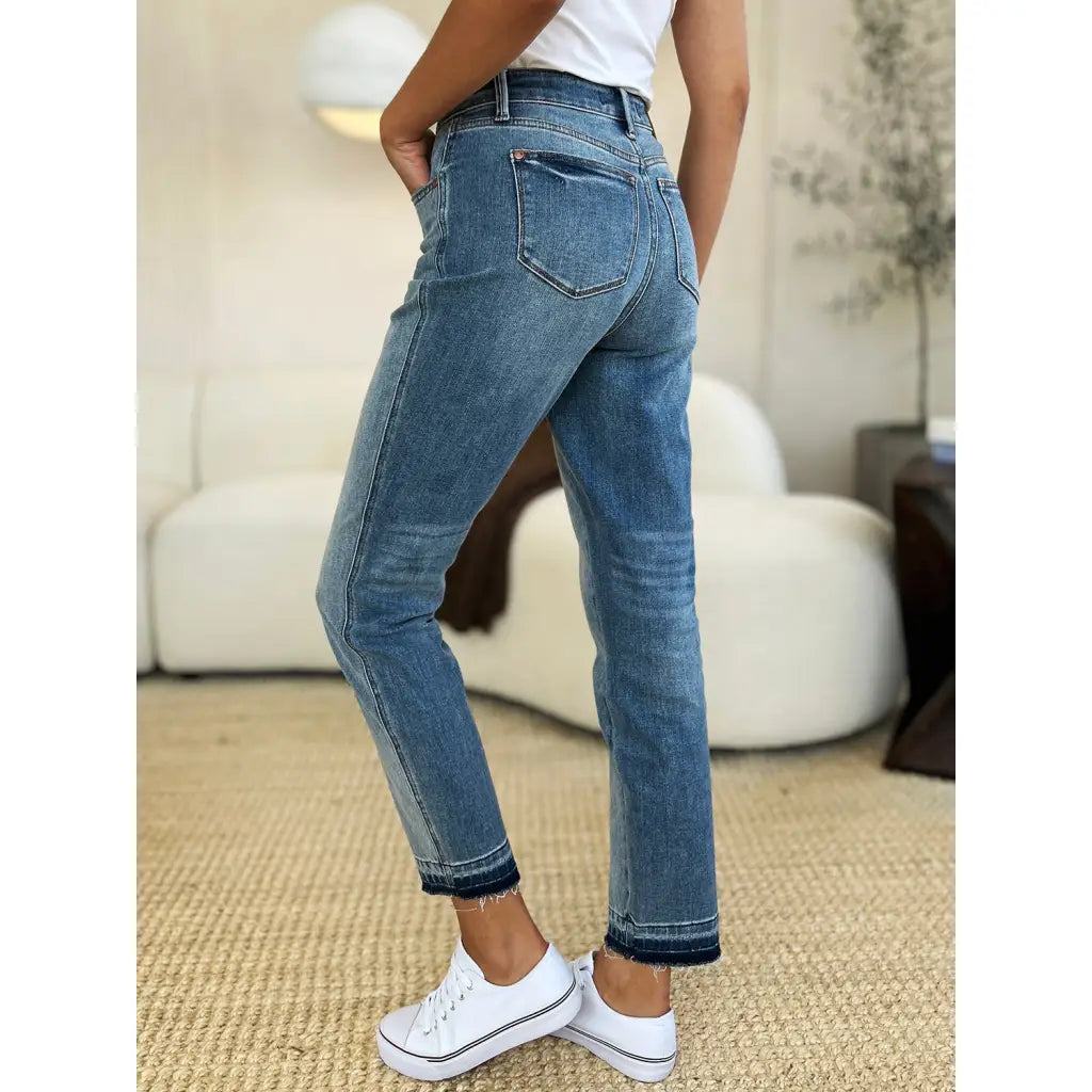 Discover the chic Judy Blue Mid Rise Rigid Magic Release Hem Jeans available in regular curvy and plus sizes. Shop