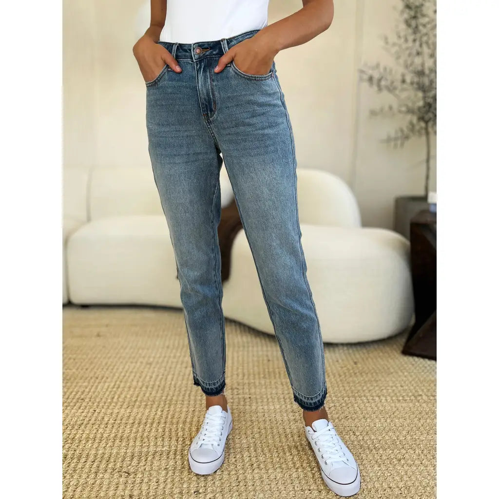 Discover the chic Judy Blue Mid Rise Rigid Magic Release Hem Jeans available in regular curvy and plus sizes. Shop