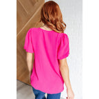 Hot pink puff sleeve blouse with V-neck and flowy fit. Available in standard curvy plus sizes. Lightweight bold &