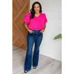 Hot pink puff sleeve blouse with V-neck and flowy fit. Available in standard curvy plus sizes. Lightweight bold &