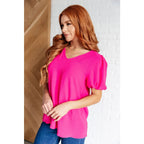 Hot pink puff sleeve blouse with V-neck and flowy fit. Available in standard curvy plus sizes. Lightweight bold &