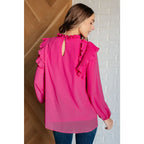 Discover the My Good Graces Ruffled Blouse a romantic pink mock neck top with balloon sleeves. Plus it’s available