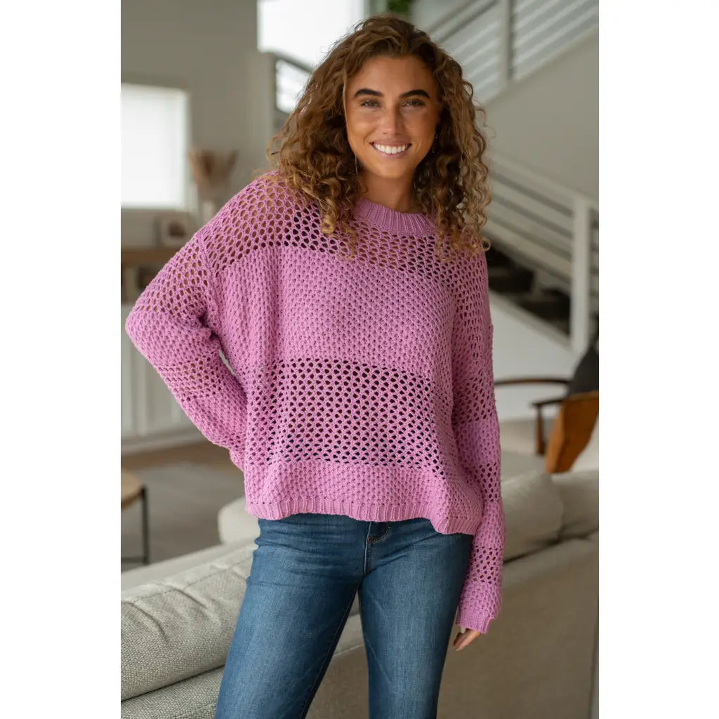 Our Latest Love sweater combines a cozy loose pink knit with block stripes for chic look. The ribbed crewe round