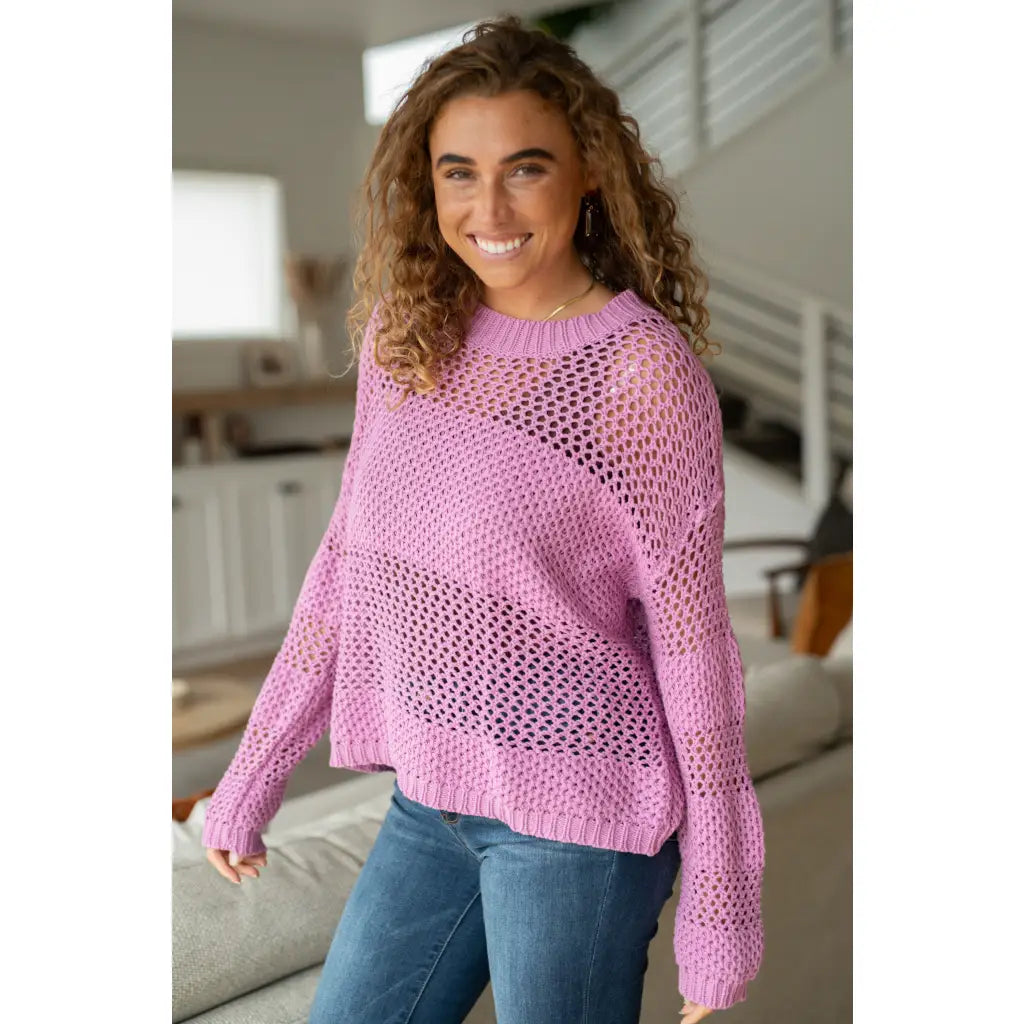 Our Latest Love sweater combines a cozy loose pink knit with block stripes for chic look. The ribbed crewe round