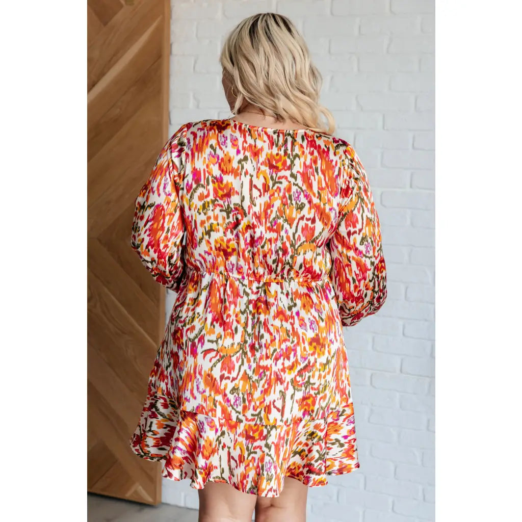 Our Once Upon a Dream Mini Dress features an abstract floral print with flattering v-neckline and billowy cased elastic
