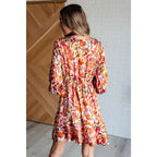 Our Once Upon a Dream Mini Dress features an abstract floral print with flattering v-neckline and billowy cased elastic