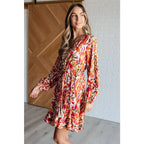 Our Once Upon a Dream Mini Dress features an abstract floral print with flattering v-neckline and billowy cased elastic