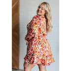 Our Once Upon a Dream Mini Dress features an abstract floral print with flattering v-neckline and billowy cased elastic