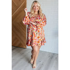 Our Once Upon a Dream Mini Dress features an abstract floral print with flattering v-neckline and billowy cased elastic