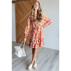 Our Once Upon a Dream Mini Dress features an abstract floral print with flattering v-neckline and billowy cased elastic