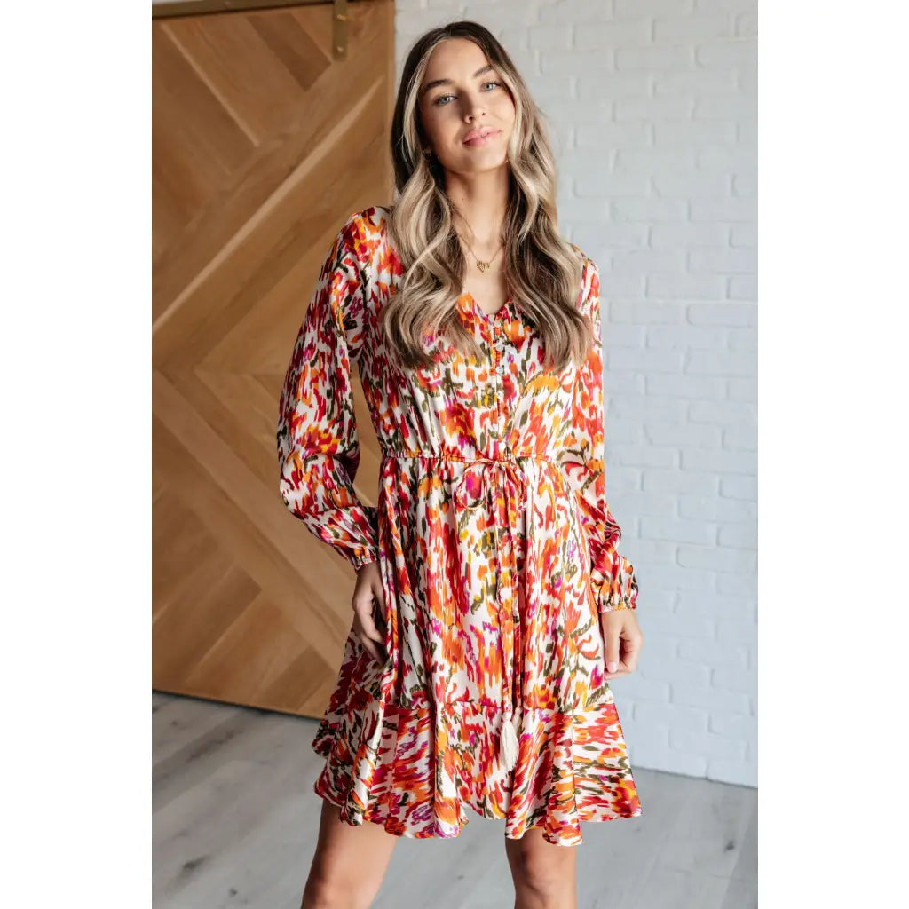 Our Once Upon a Dream Mini Dress features an abstract floral print with flattering v-neckline and billowy cased elastic