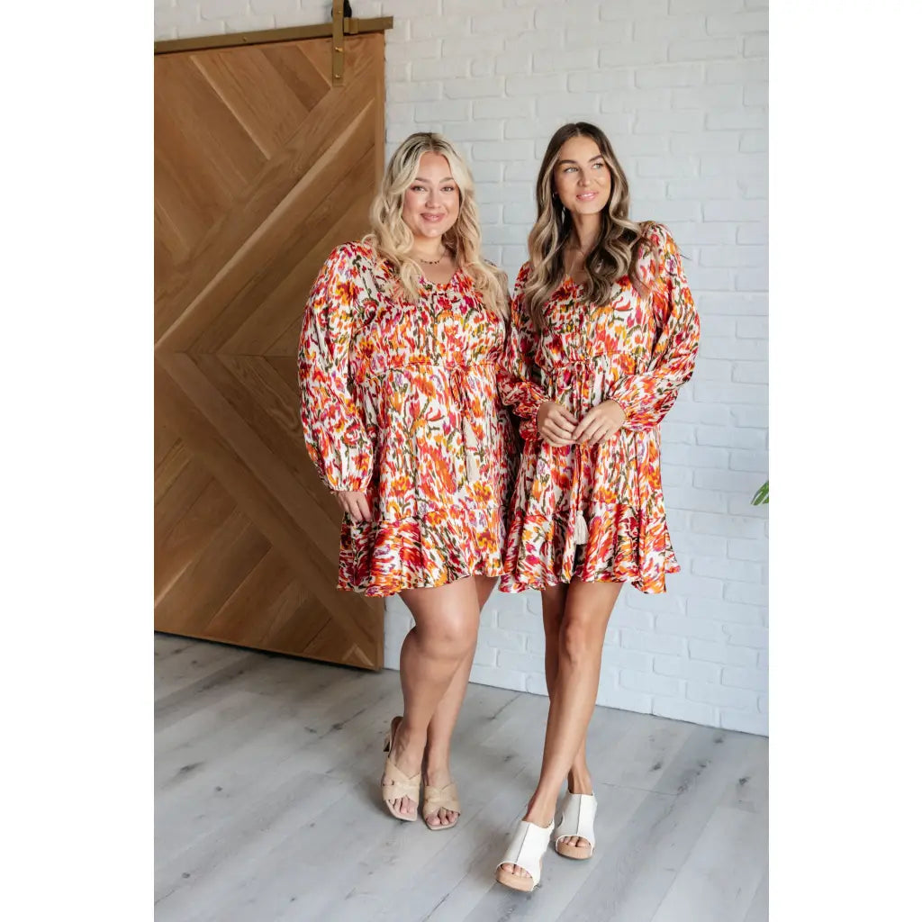 Our Once Upon a Dream Mini Dress features an abstract floral print with flattering v-neckline and billowy cased elastic