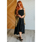 Chic black crinkle maxi dress with pockets ruffle hem and tie back. A flattering essential for effortless everyday
