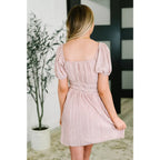 Our Pale Pink Plisse Mini Dress is an adorable little poly satin frock that boasts a cute cased elastic shoulder