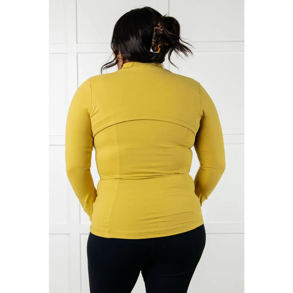 Our Pear-fectly Yellow Activewear Jacket is form-fitting and features a brushed microfiber material with mock neckline
