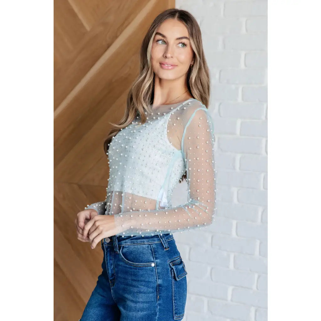 Our Pearl Diver Mesh Layering Top in Light Cyan is a stretchy long sleeve top embellished with faux pearls