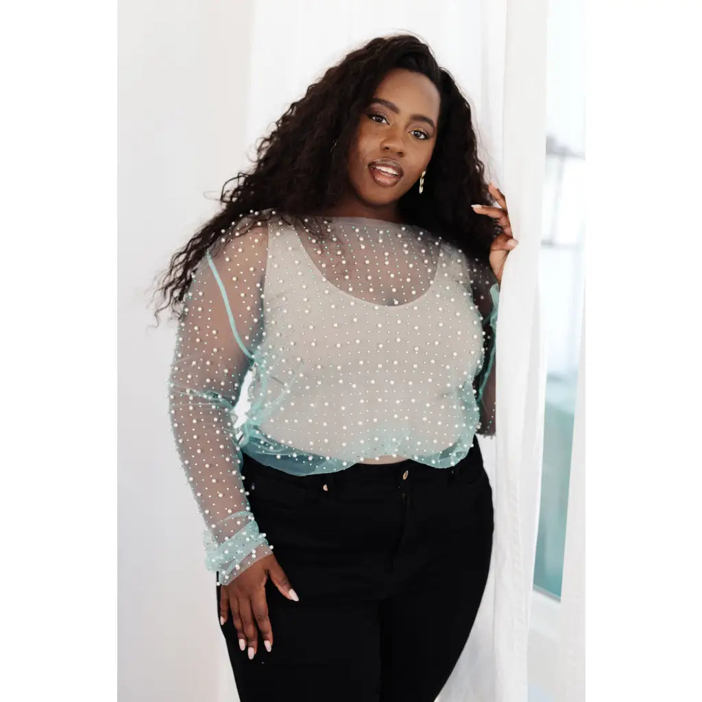 Our Pearl Diver Mesh Layering Top in Light Cyan is a stretchy long sleeve top embellished with faux pearls
