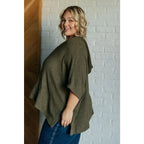 Our Perfectly Poised Hooded Poncho is crafted from a soft olive lightweight and stretchy. ribbed jersey knit.