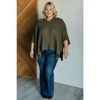 Our Perfectly Poised Hooded Poncho is crafted from a soft olive lightweight and stretchy. ribbed jersey knit.