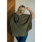 Our Perfectly Poised Hooded Poncho is crafted from a soft olive lightweight and stretchy. ribbed jersey knit.