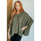 Our Perfectly Poised Hooded Poncho is crafted from a soft olive lightweight and stretchy. ribbed jersey knit.