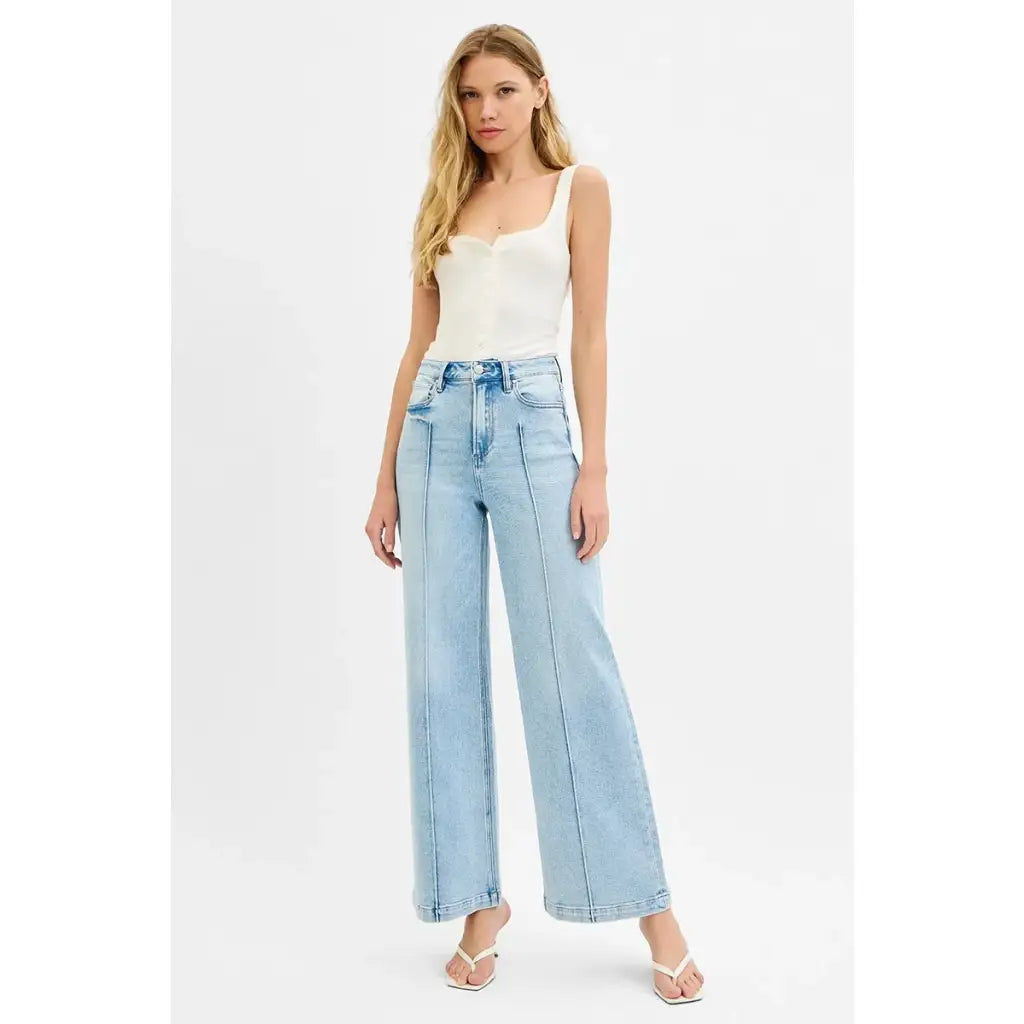 Chic pintuck detailed wide leg jeans with high waist stretch comfort and modern style. Elevated everyday stretchy denim