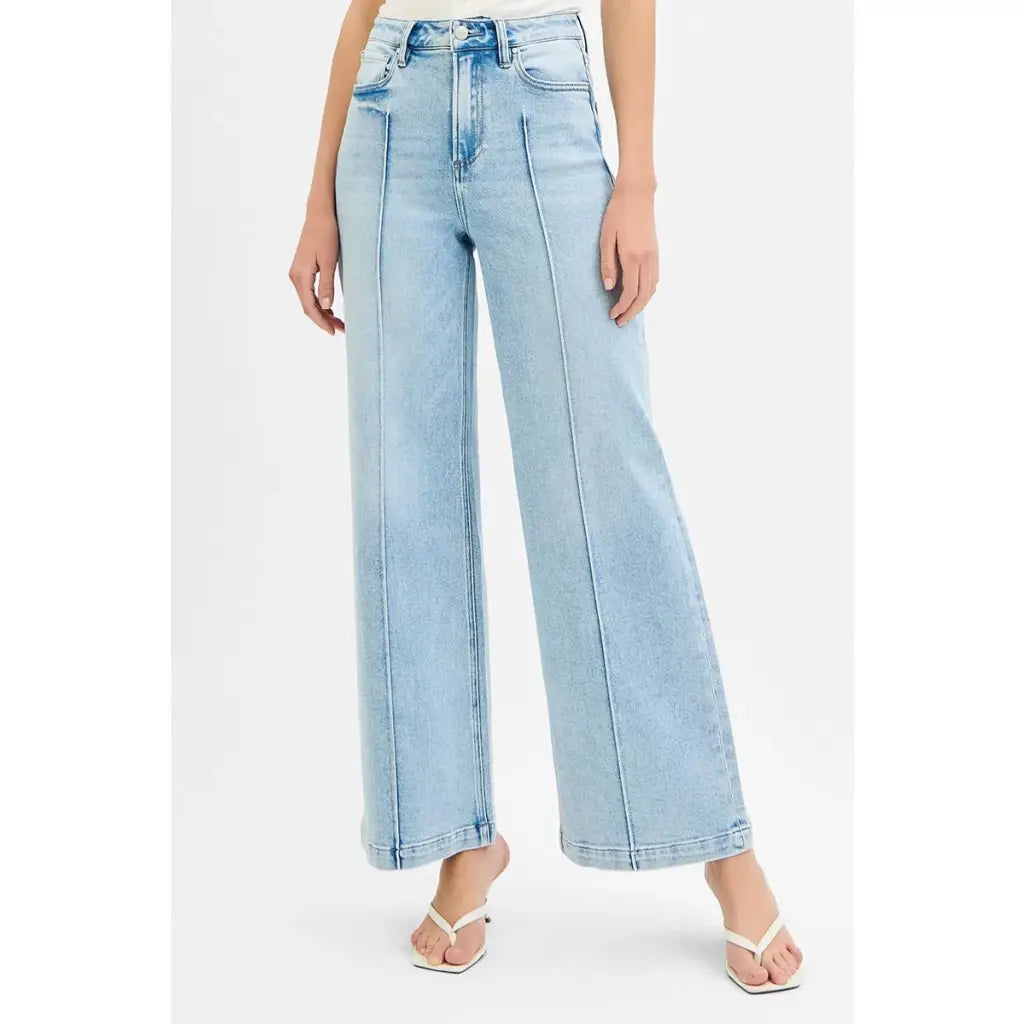 Chic pintuck detailed wide leg jeans with high waist stretch comfort and modern style. Elevated everyday stretchy denim