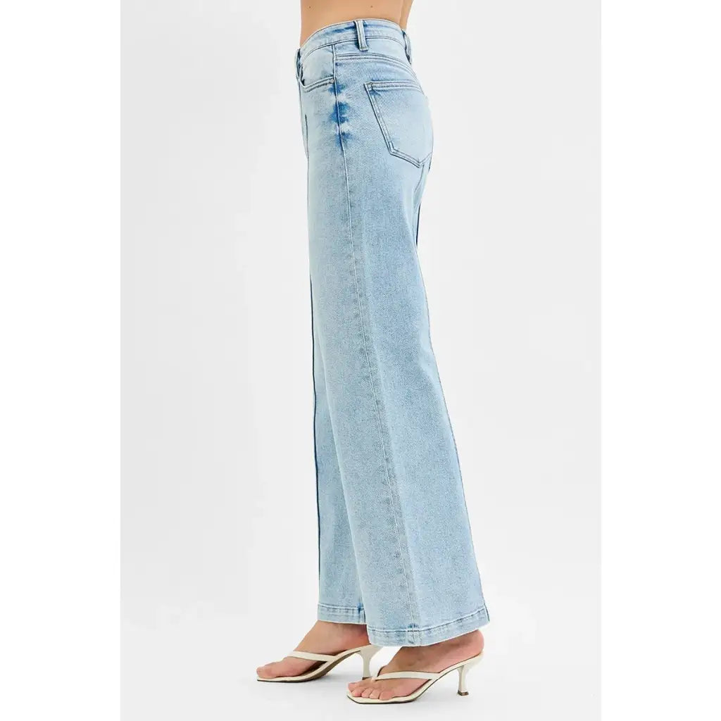 Chic pintuck detailed wide leg jeans with high waist stretch comfort and modern style. Elevated everyday stretchy denim