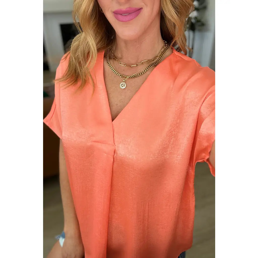 Discover effortless chic with our Pleat Front V-Neck Top in Persimmon! Made of luxurious satin this blouse features