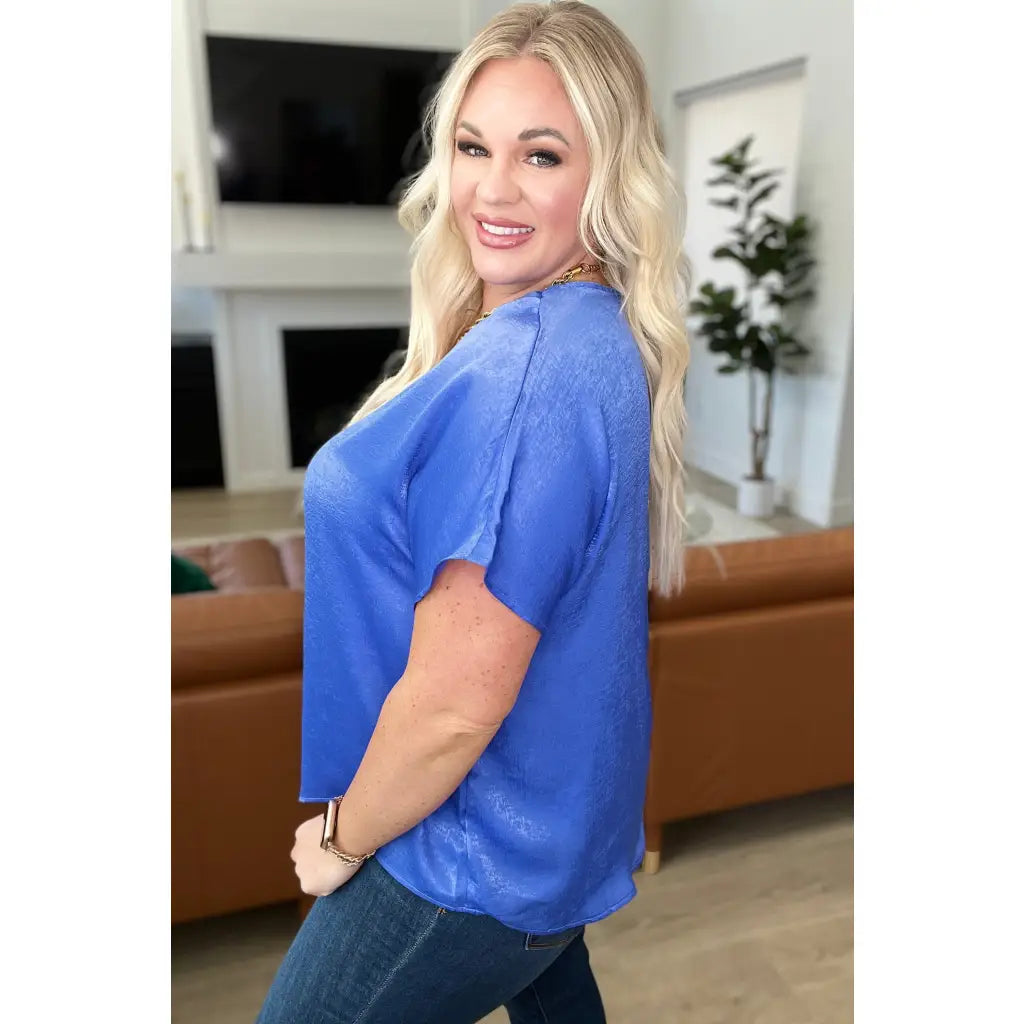 Discover effortless elegance with our Pleat Front V - Neck Top in Royal Blue! Made of luxurious satin this short sleeve