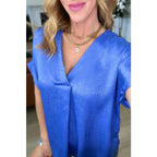 Discover effortless elegance with our Pleat Front V - Neck Top in Royal Blue! Made of luxurious satin this short sleeve